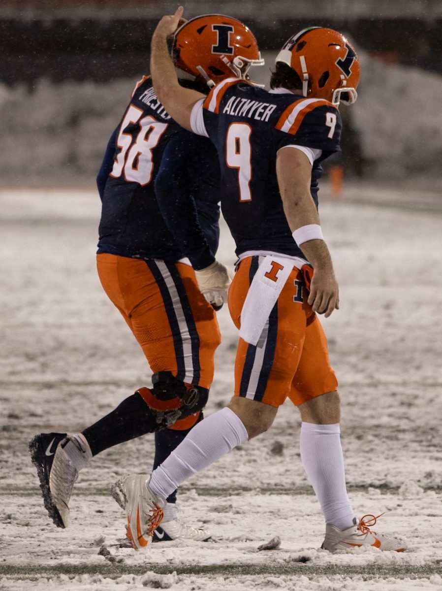 Altmyer and senior offensive lineman  Melvin Priestly walk off the field during Illinois' game against Northwestern on Nov. 30. 