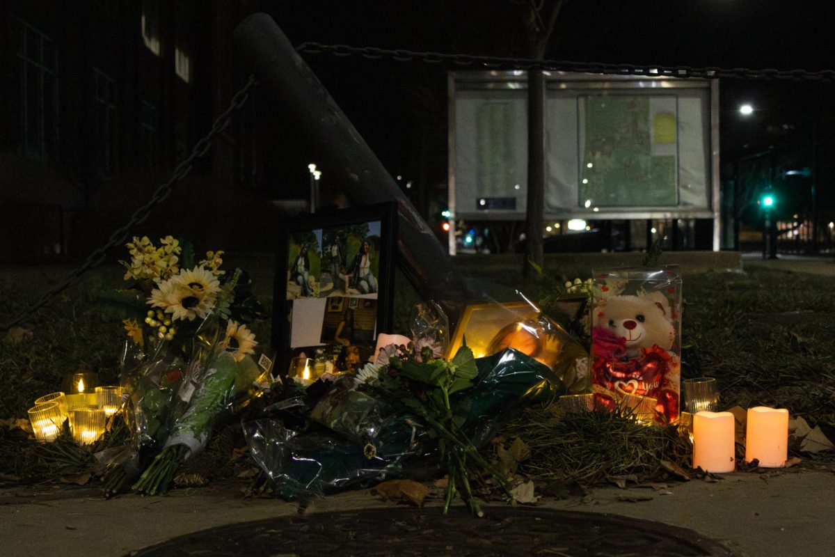 Flowers, teddy bears, photos and candles adorn a Dec. 22 memorial for Ororo Taylor, the 22-year-old Urbana resident who died after a driver struck her and fled on Dec. 20, while she was walking on campus. The search for that driver, who also hit a UIPD squad car, injuring an officer, is ongoing. 