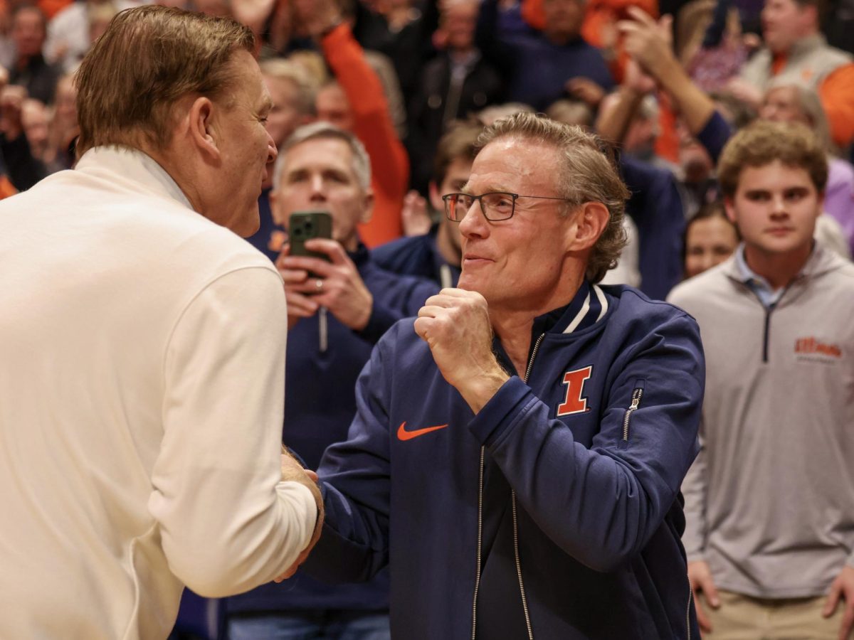 University alum Larry Gies shakes head coach Brad Underwood's hand after Illiinois defeated Tennessee in Nashville on Dec. 6. Gies donated $100 million to the Illinois Division of Intercollegiate Athletics earlier this year.