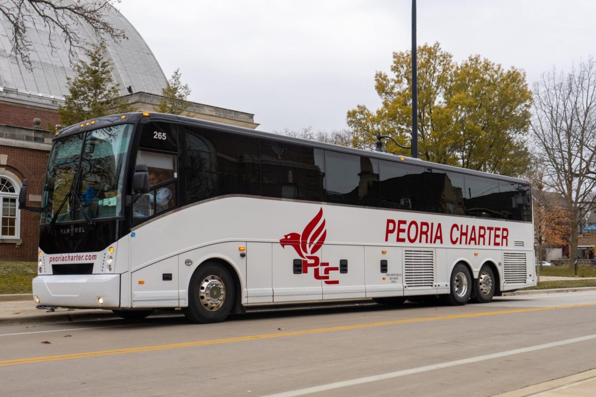 A Peoria Charter bus stands at a pickup location on Armory Avenue on Nov. 17, 2022. The company filed for bankruptcy but said it will continue operating normally.