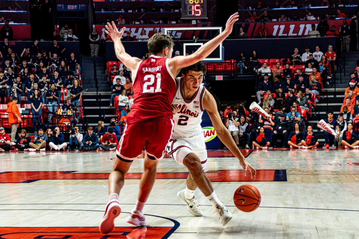 Junior wing Andrej Stojaković drives against Nebraska junior guard Pryce Sandfort in Illinois' 80-83 loss to Nebraska on Dec. 13.