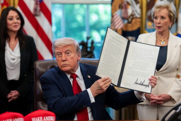 President Donald Trump signs executive orders alongside Secretary of Education Linda McMahon on Apr. 23. The Education Department announced this week it will end a Biden-era student loan forgiveness program.