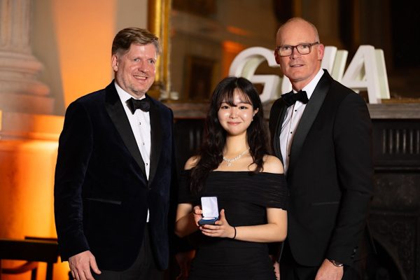 Simon Coveney, former Irish government minister, presents Leana Shin with the Thomas Clarkson Medal at the Global Undergraduate Awards Gala.