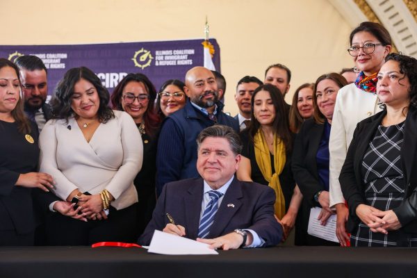 Gov. JB Pritzker signs House Bill 1312 in Chicago on Dec. 9. The bill prohibits United States Immigration and Customs Enforcement agents from making arrests at courthouses and allows people arrested by ICE to sue the agency for constitutional violations.