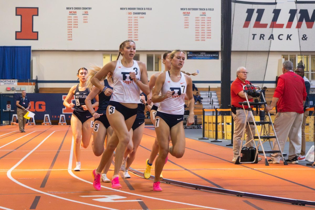 Mabry Bruhn (left) and Nicole Poglitsch (right) lead the pack in the women’s 1 mile run at the Illini Open in the Armory on Jan. 10.