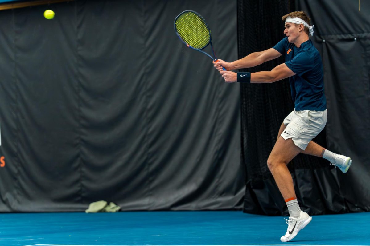 Freshman Adam Jilly rises to return a backhand against Xavier at Atkins Tennis Center on Jan 30.