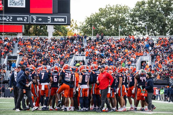 Illinois huddles together for a timeout during the game against Rutgers on Nov. 1, 2025. Illinois went on to win the game, 35-13.