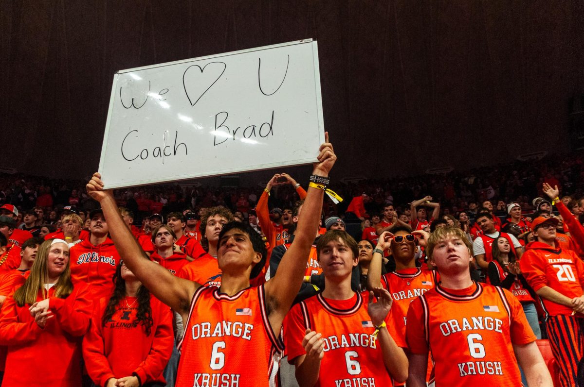 Members of the Orange Krush hold up a whiteboard in appreciate of head coach Brad Underwood in Illinois' victory over Texas Tech on Nov. 11.