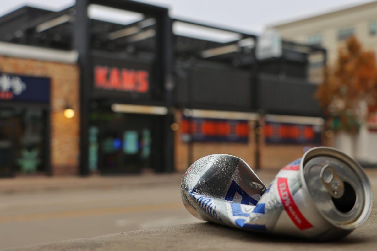 A crushed can lays littered on a cement ledge across from the campus bar KAMS on Nov. 20.