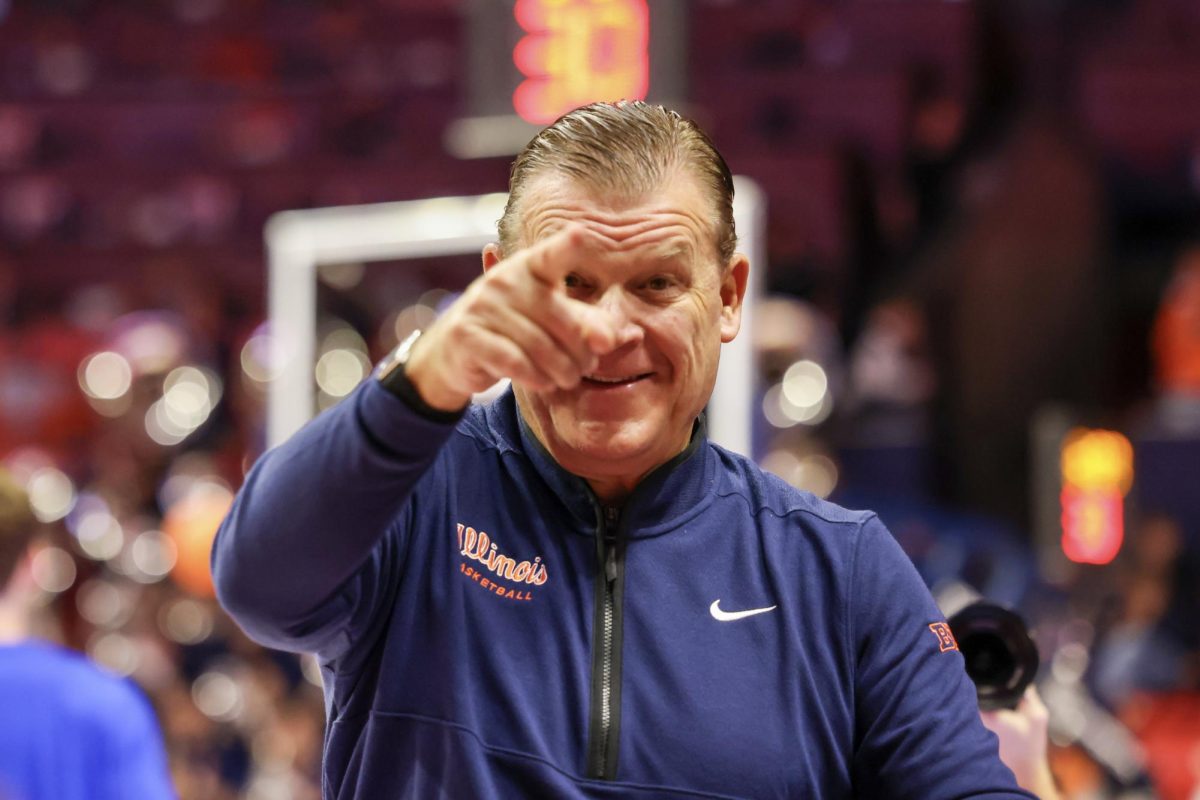 Illinois head coach Brad Underwood points to the Orange Krush ahead of tipoff against FGCU on Nov. 7.