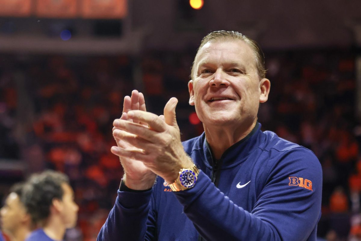 Illinois head coach Brad Underwood acknowledges the Orange Krush ahead of tipoff against FGCU on Nov. 7.