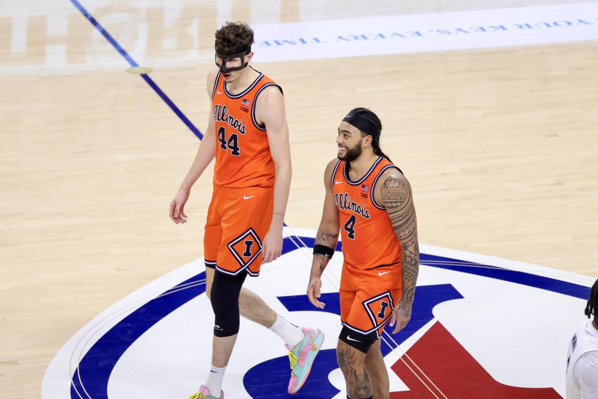 Junior center Zvonimir Ivišić and senior guard Kylan Boswell walk back to the Illini bench during a stop in play at The Palestra on Jan. 3. Ivišić had six points, 10 rebounds and five blocks, while Boswell led Illinois with 18 points in a win over Penn State.
