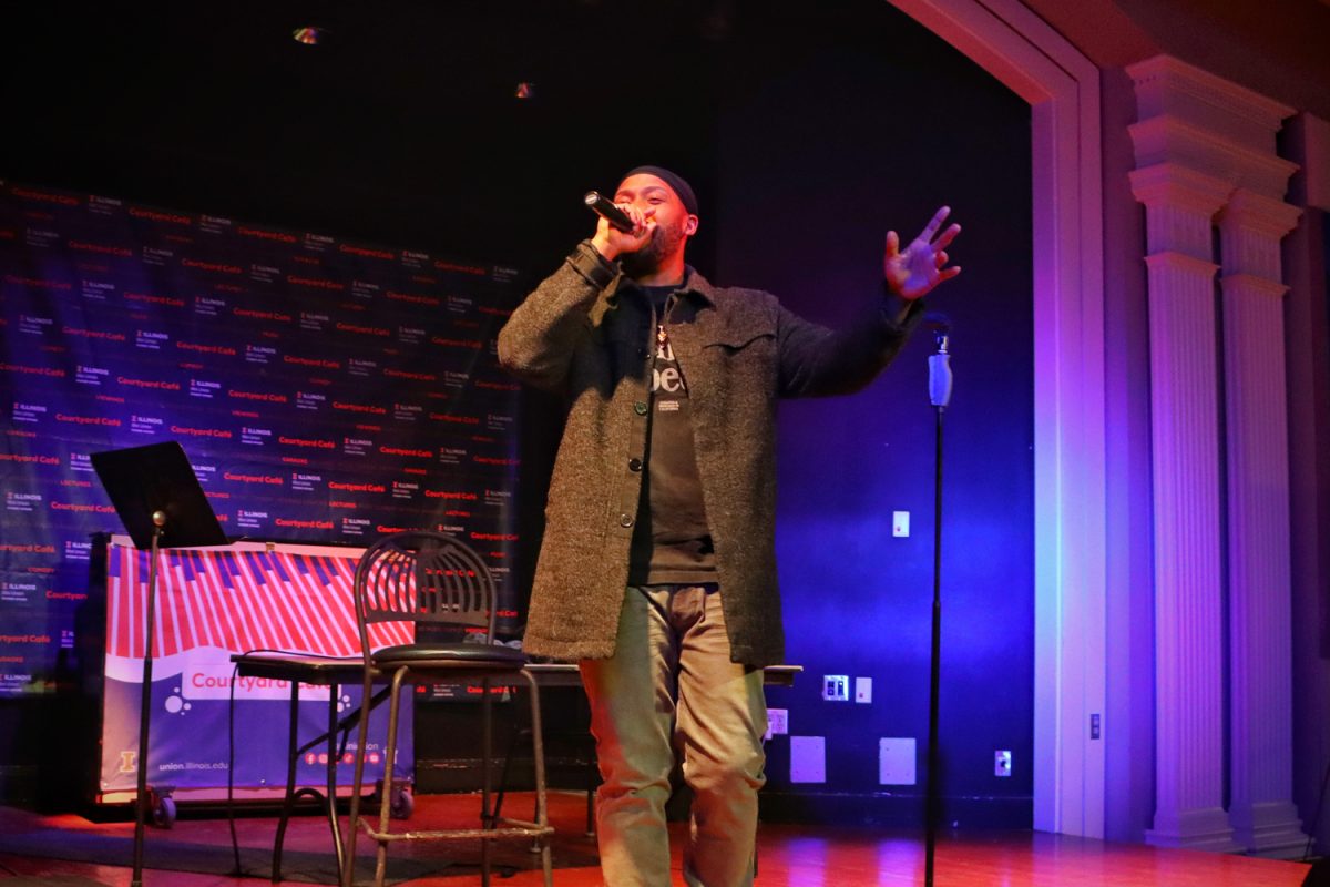Artist Jarrel Young, social work alumni, performs “Illini Anthem” on the Courtyard Cafe stage on Jan. 26. Young, co-writer and vocalist on the anthem, brought energy to the Illini Union Board’s event. Individuals can attend Musical Mondays for free at the Illini Union every Monday starting at 7pm in the Courtyard Cafe.