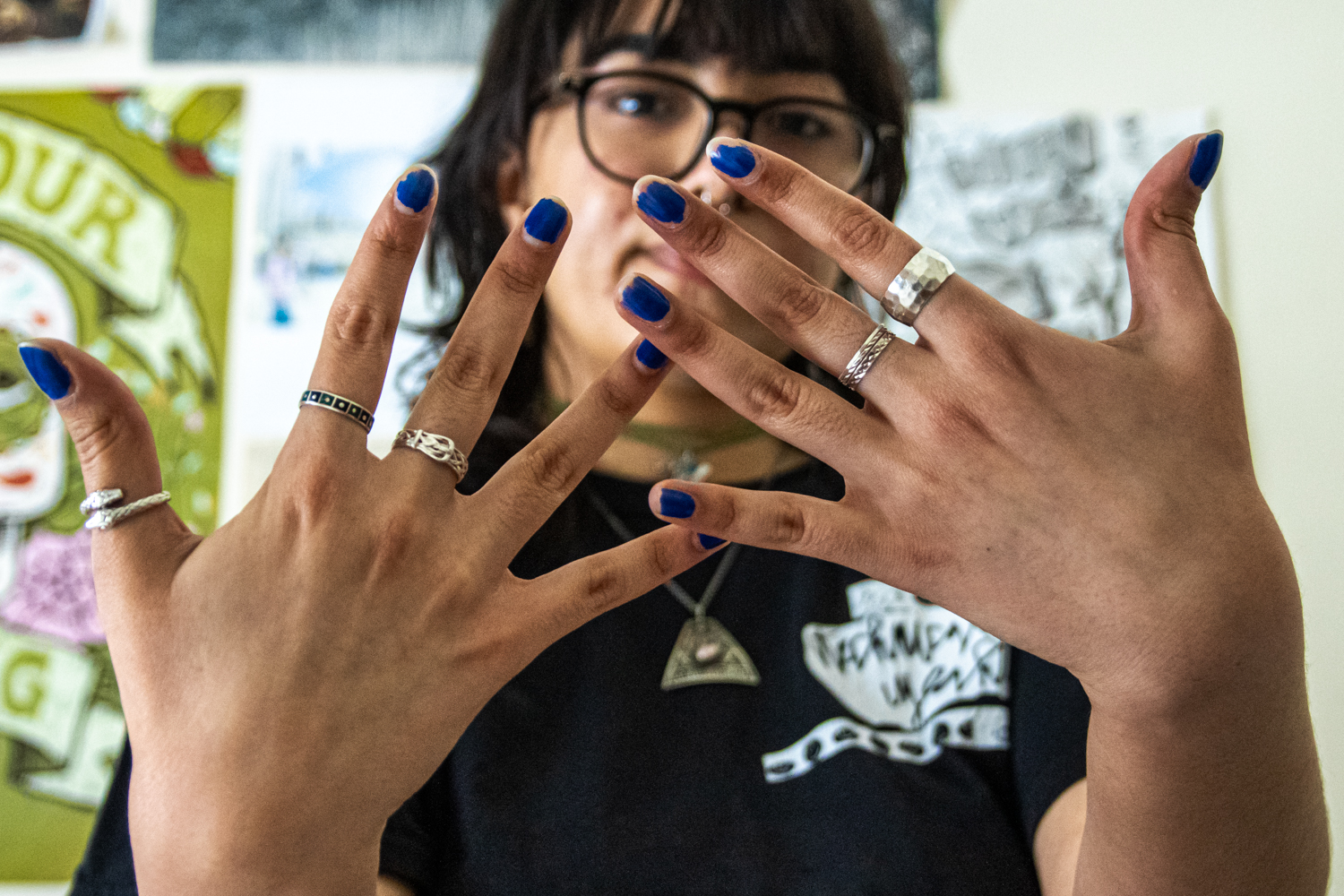 Emma Martinez, senior in FAA, holds up her hands to show off her rings on Jan. 31.