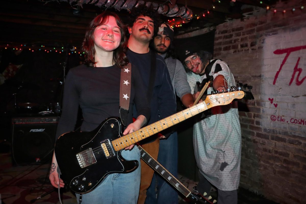 Members of Brain Sex strike a pose for a group photo during a rehearsal at the venue, The Cosmo, on Feb. 12. Madi McNamee, left, plays guitar and performs vocals; Addie Alkhas, center left, plays guitar; Rey Parikh, center right, plays drums; and Rat King Crow, right, plays bass and performs vocals. The band released its new EP, “Foreplay,” on Feb. 13 and performs across the CU area.