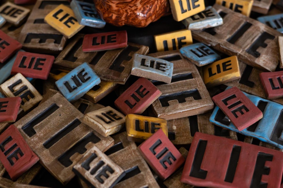 An art piece titled "The Art of the Lie" by Stephen Kaufman is on display in the Art of the Resistance art gallery at the university YMCA on Feb. 25. The gallery features many art pieces on modern political topics such as president Donald Trump and the country itself.