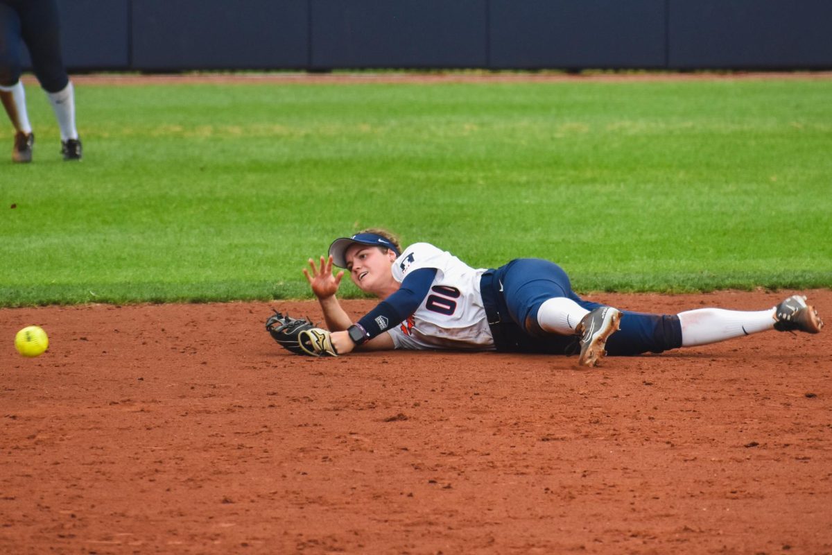 Infielder Ava Moore throws the ball to the third base after making a diving stop. 