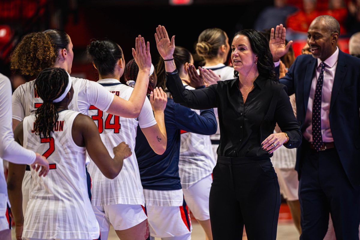 Illinois head coach Shauna Green high-fives her players leading up to their game against Northwestern on Jan. 18.