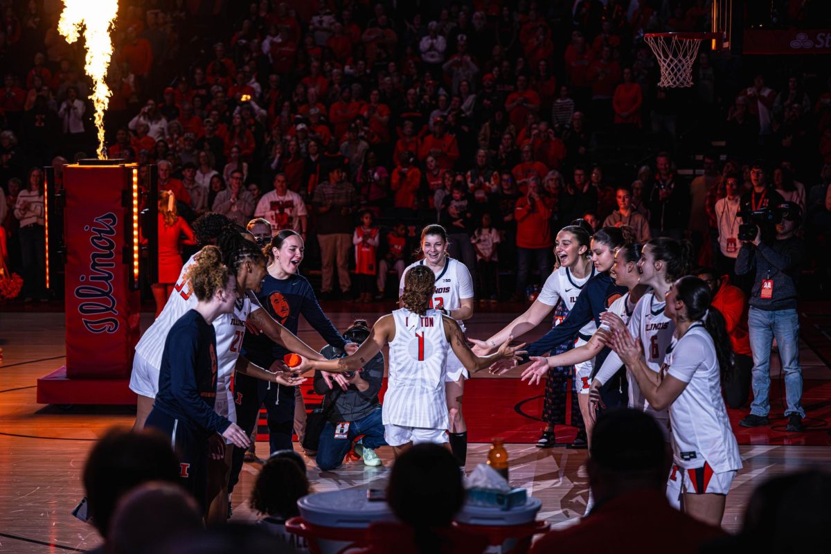 Sophomore guard Aaliyah Guyton runs out through a tunnel of her teammates leading up to the Illinois v. Northwestern game on Jan. 18.
