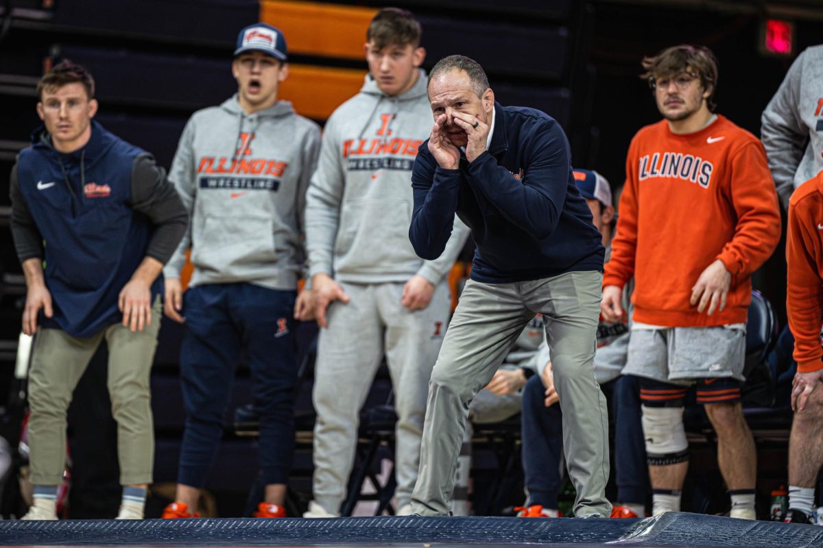 Interim head coach Jeremy Hunter yells out from the bench during the Illinois v. Rutgers dual on Jan. 24. Illinois won the dual 17-16.