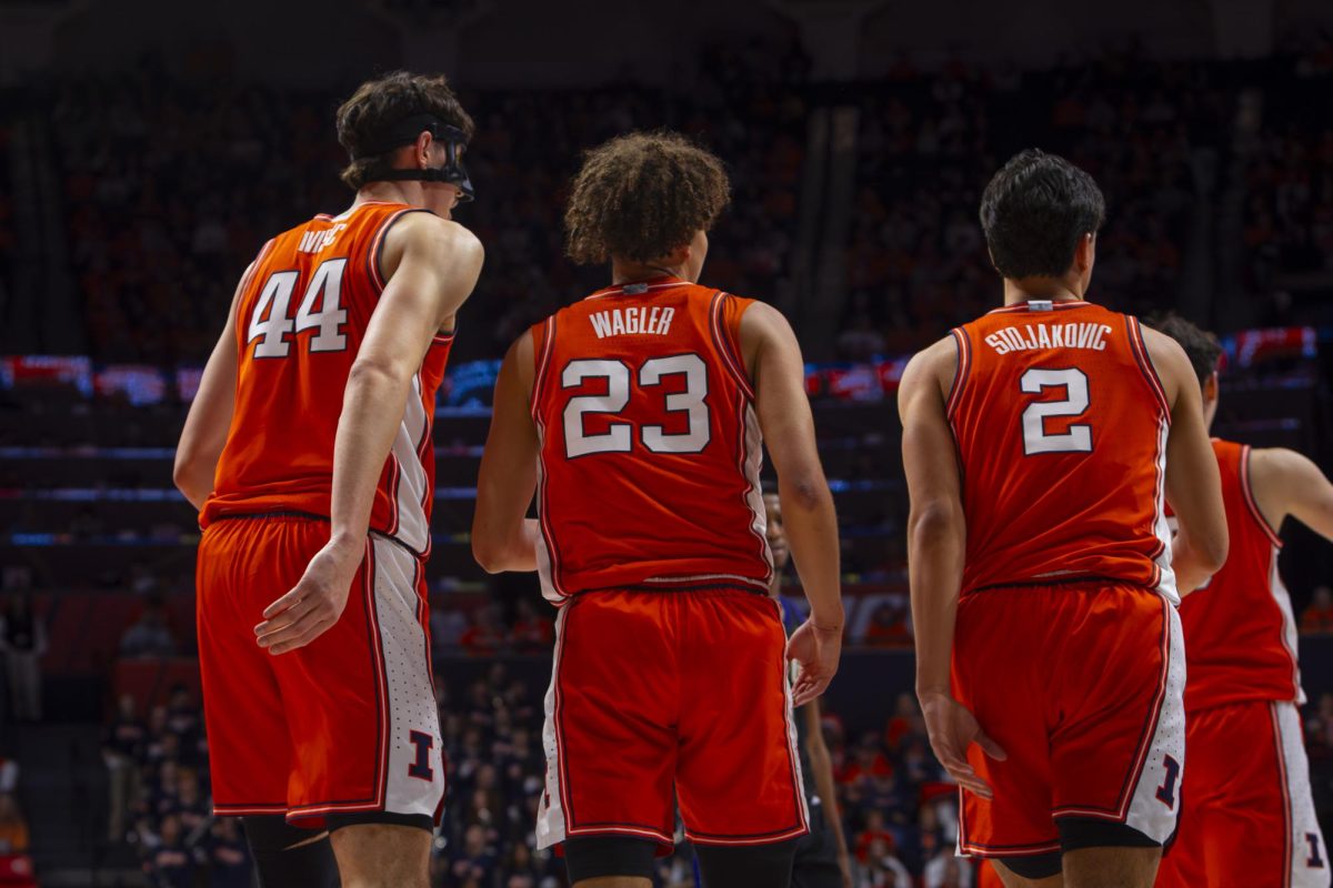 Junior forward Zvonimir Ivišiċ (left), freshman guard Keaton Wagler (center), and junior guard Andrej Stojakoviċ (right) return to the Illinois bench during a break in game vs Washington at State Farm Center on Jan. 29.