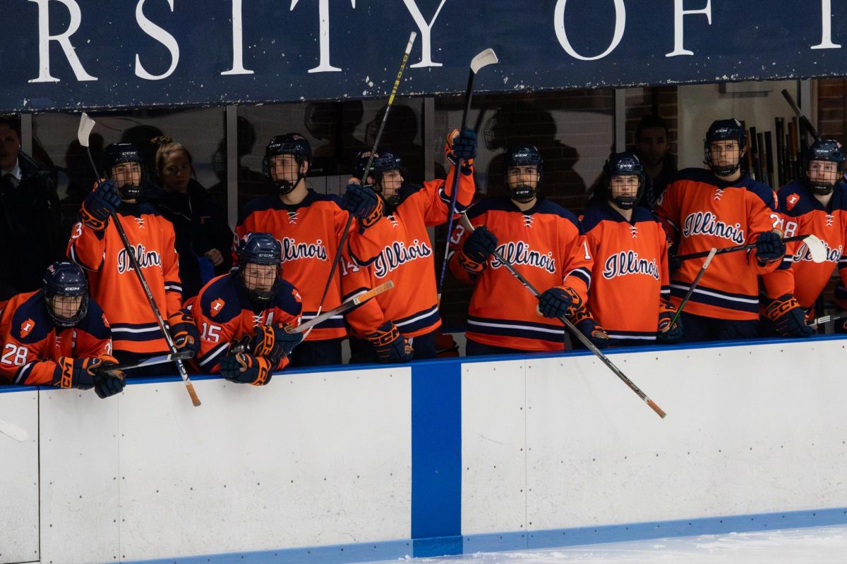 Illinois bangs on the University of Illinois Ice Arena walls with its hockey sticks before its match against Roosevelt began on Dec. 5, 2025.
