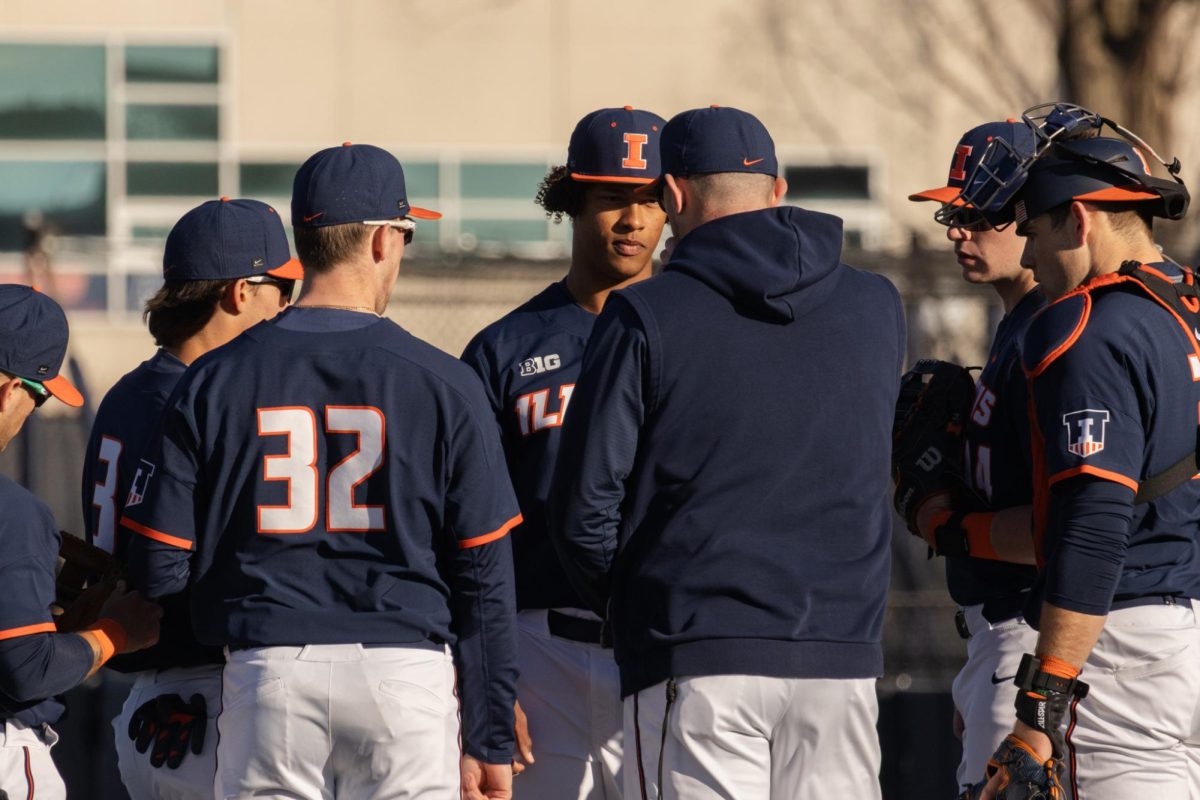 Freshman right-handed pitcher Ike Young meets with his teammates at the mound during a game against Lindenwood on Feb. 25.
