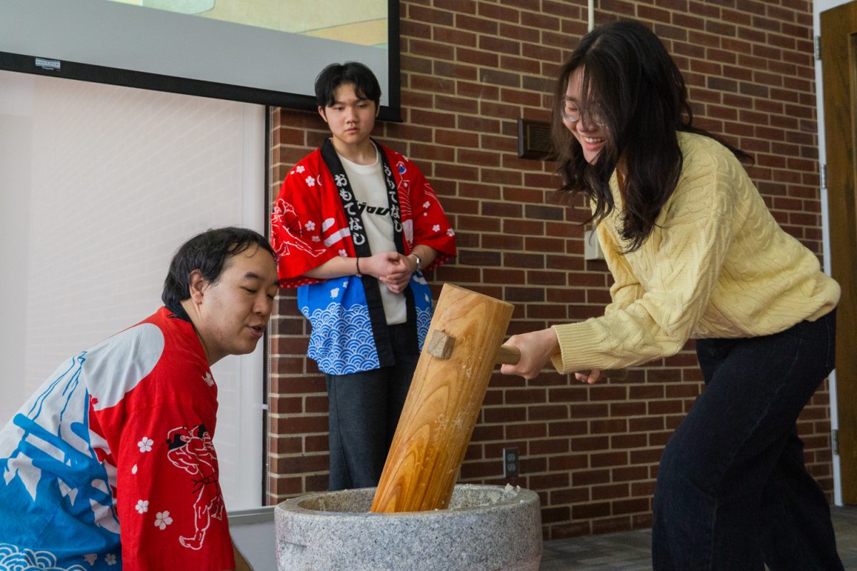 Hikaru Takeyama assists a volunteer at the Mochitsuki event while his student DJ Wang, a junior at University Laboratory High School, watches on. The event, held at the Literatures, Cultures, and Linguistics Building on Feb. 9 allowed participants to join the mochi-making process and make their own fresh mochi.