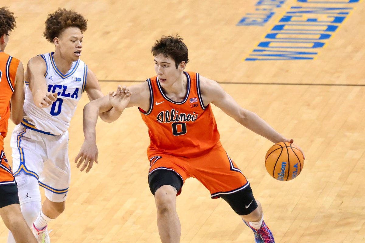 Freshman forward David Mirković dribbles the ball against UCLA sophomore guard Trent Perry in Illinois' overtime loss to UCLA on Feb. 21.