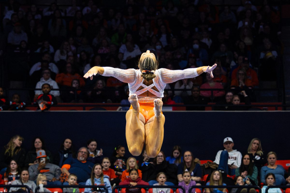 Senior Alea Byrne performs a jump on the beam during her routine Feb. 22 in the State Farm Center. The meet versus UCLA drew a crowd of over 6,000 people to the stadium, breaking a record for Illinois women’s gymnastics attendance.