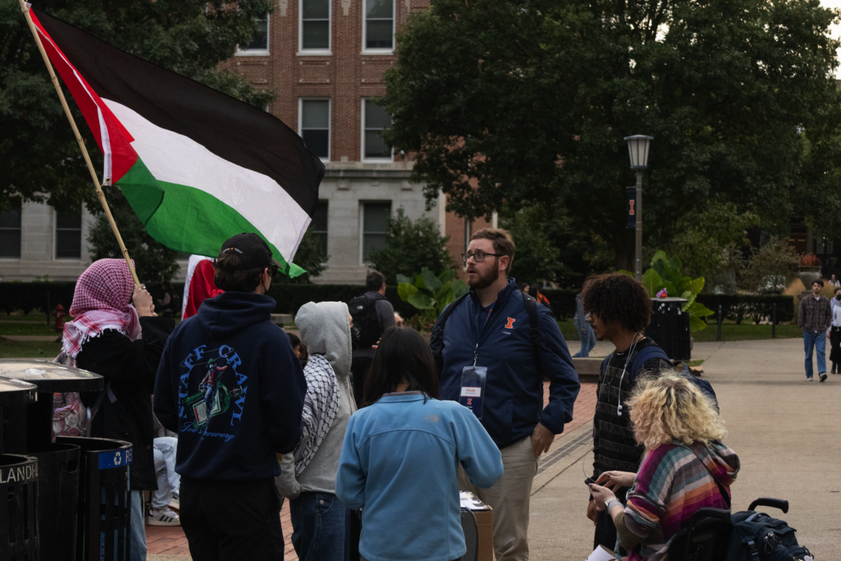 Tyler Schaffer, case manager in the Office of the Dean of Students and member of the the I-Team, speaks with pro-Palestine demonstrators at Anniversary Plaza on Oct. 7, 2025. The Daily Illini outlines the roles, responsibilities and criticism of the I-Team.