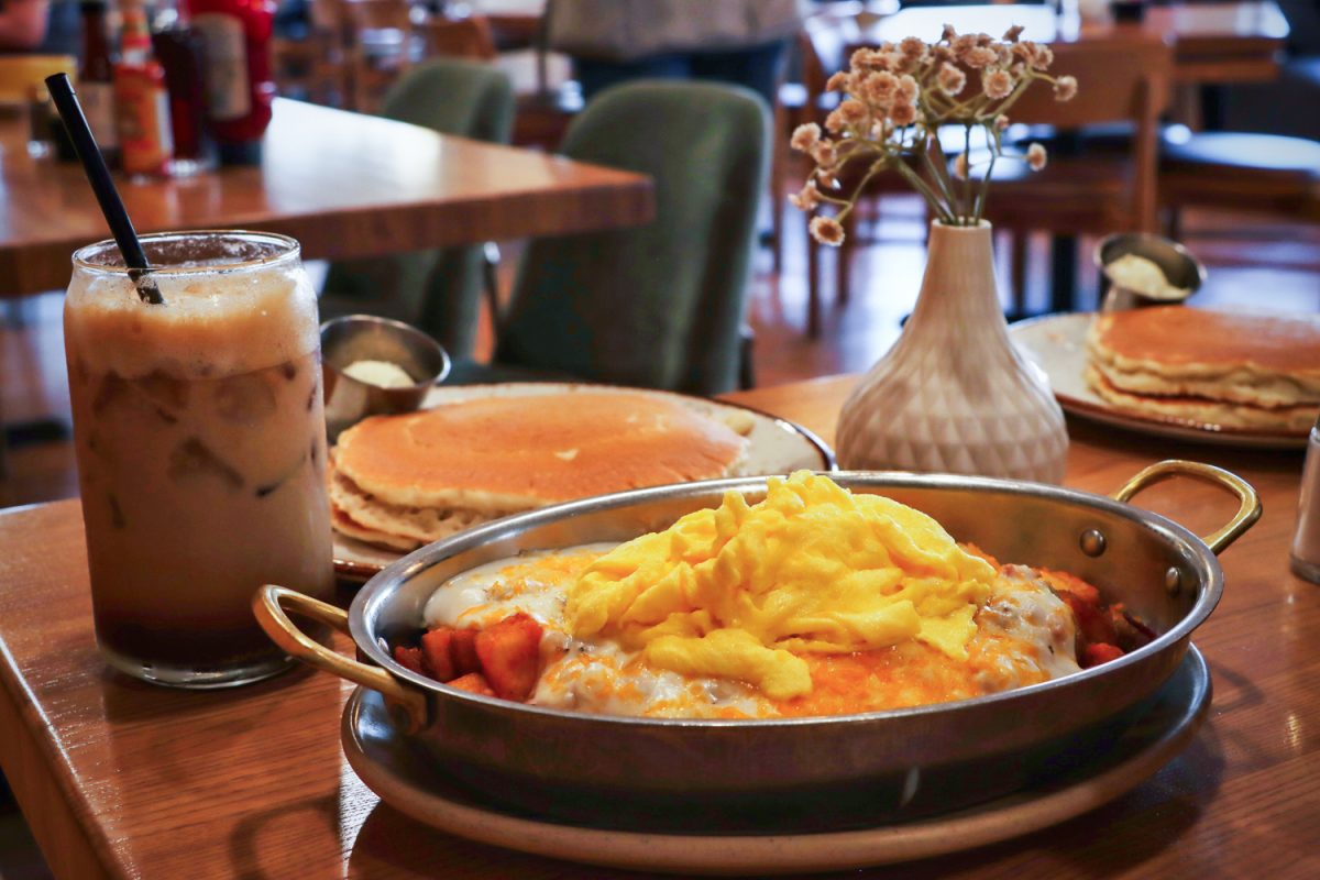 A full spread of breakfast items sits on a table at Maple & Yolk Feb. 18, including an Iced Maple Oatmilk Shaken Espresso, a Hash Stack Skillet and pancakes. The restaurant rebranded in 2025 and has served the CU community for more than 30 years with breakfast staples and an expansive drink bar.