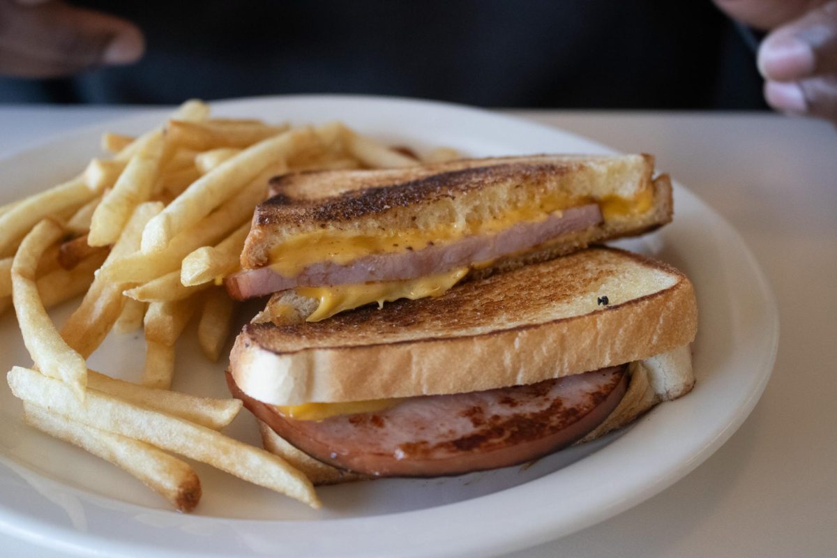 A plate of grilled ham and cheese and fries sits on a table at Merry-Ann's diner on South Neil Street in Champaign on Feb. 21.