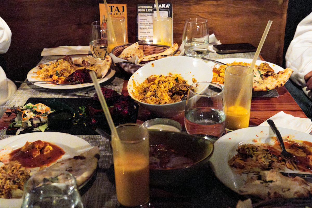 A table of four is packed with various dishes at The Himalayan Chimney on the corner of W Church Street and N State Street on Feb 28, 2025.