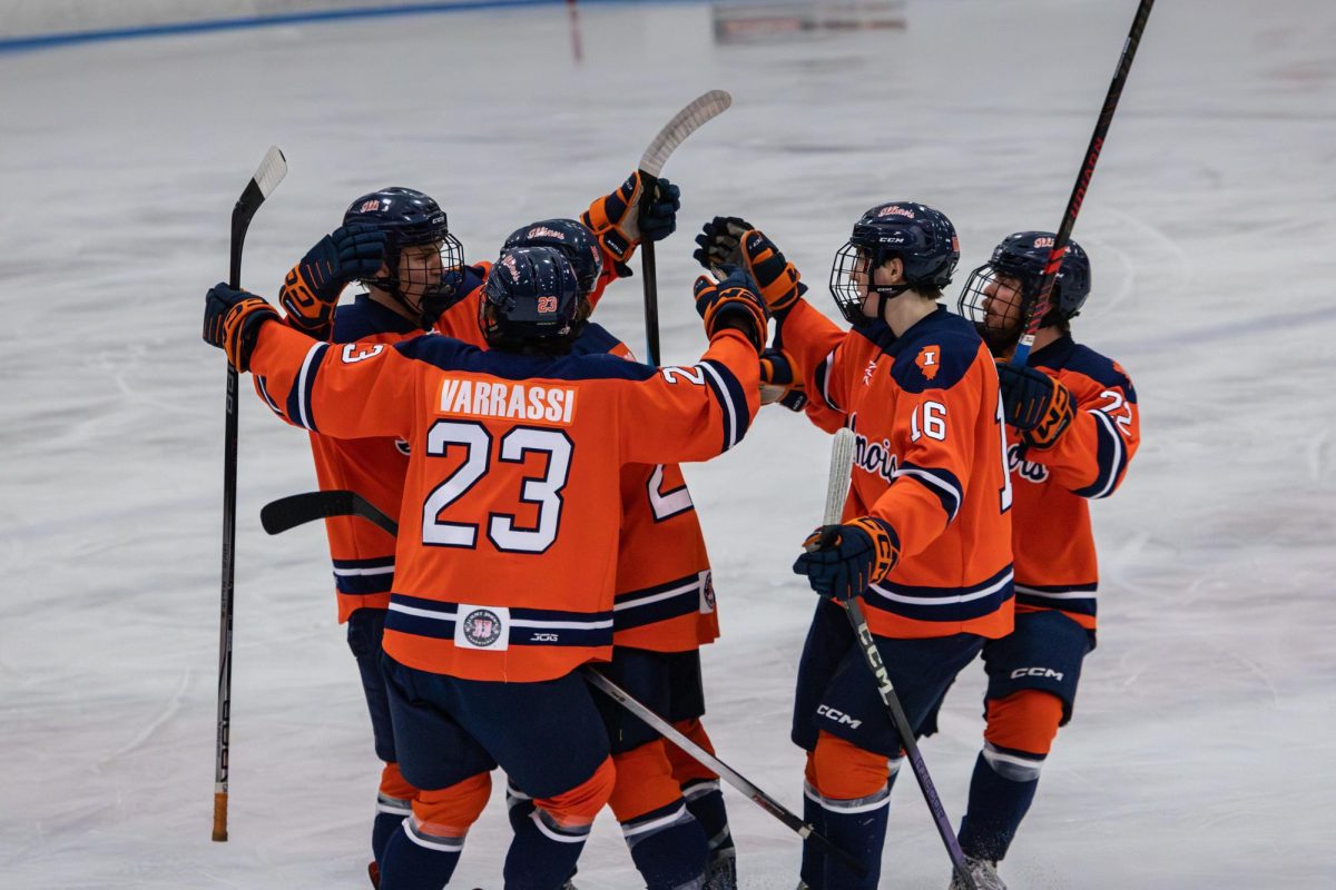 Illinois players celebrate after freshman defensemen Adrian Wisniewski scored the first goal against Cincinnati at the Illinois Ice Arena on Feb. 28.