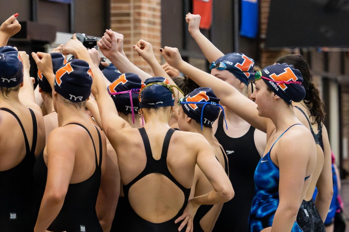 The Illinois swim and dive team celebrate after beating Eastern Illinois 157-77 at Illinois' last home meet of the season on Feb. 7 at the ARC pool. This final meet was the team's senior night, showcasing their four senior swimmers one last time at home.