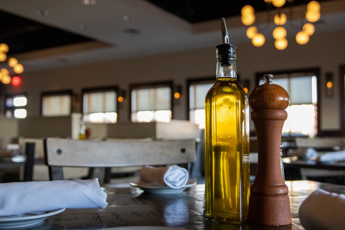 Olive oil and a pepper grinder sit on a table set for four at Biaggi’s Ristorante Italiano in Champaign March 3, 2025. The restaurant’s menu features classic Italian entrees and desserts.