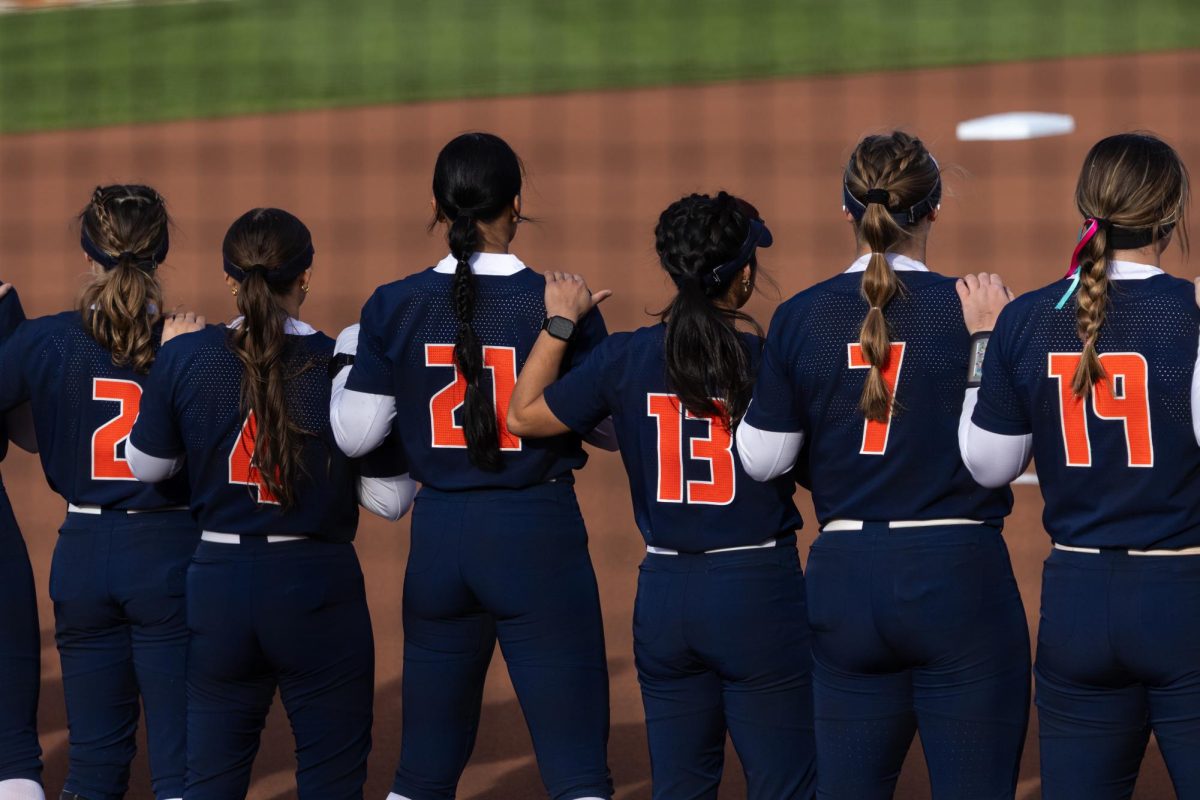 The Illinois softball team stands for the national anthem on March 13 at their first home game of the season against Iowa.