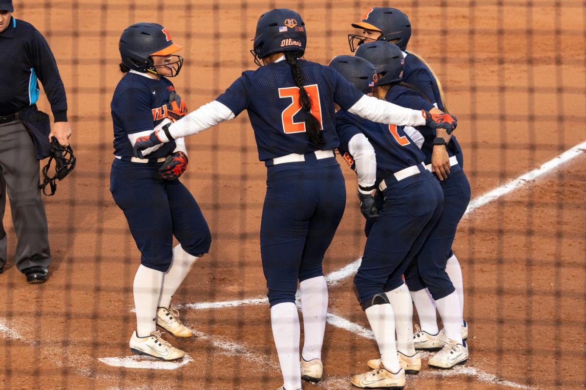 Sophomore infielder Keirys Click runs home and celebrates with her teammates after hitting a grand slam against Iowa during their first home game of the season on March 13.