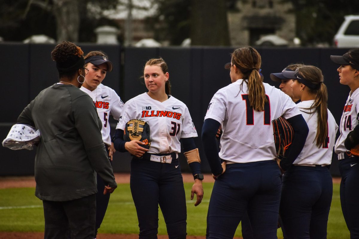 Illinois head coach Tyra Perry talks to her players during a stop in play on April 10, 2024.  