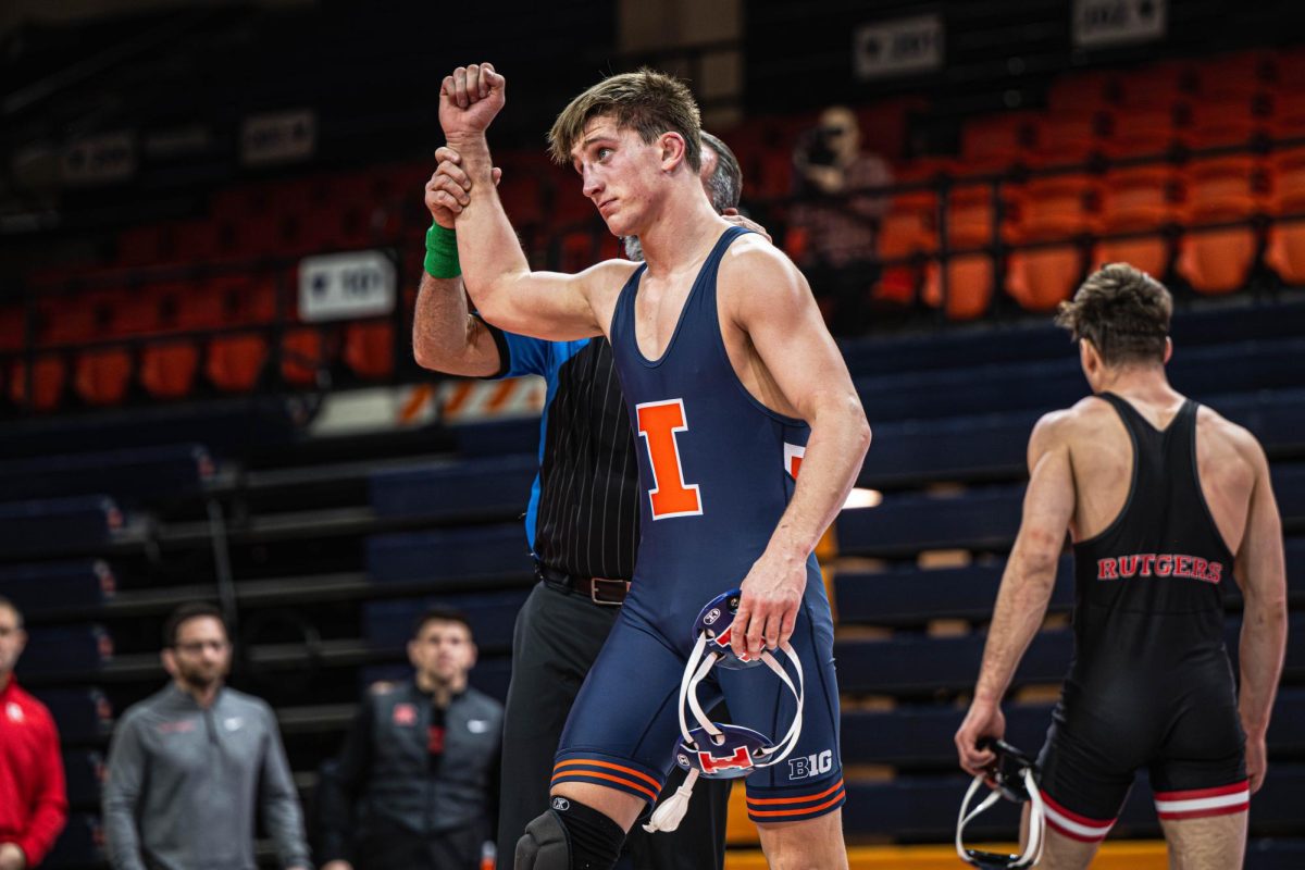 157lb redshirt sophomore Kannon Webster has his arm raised following a convincing 13-4 victory during the Illinois v. Rutgers dual on January 24.