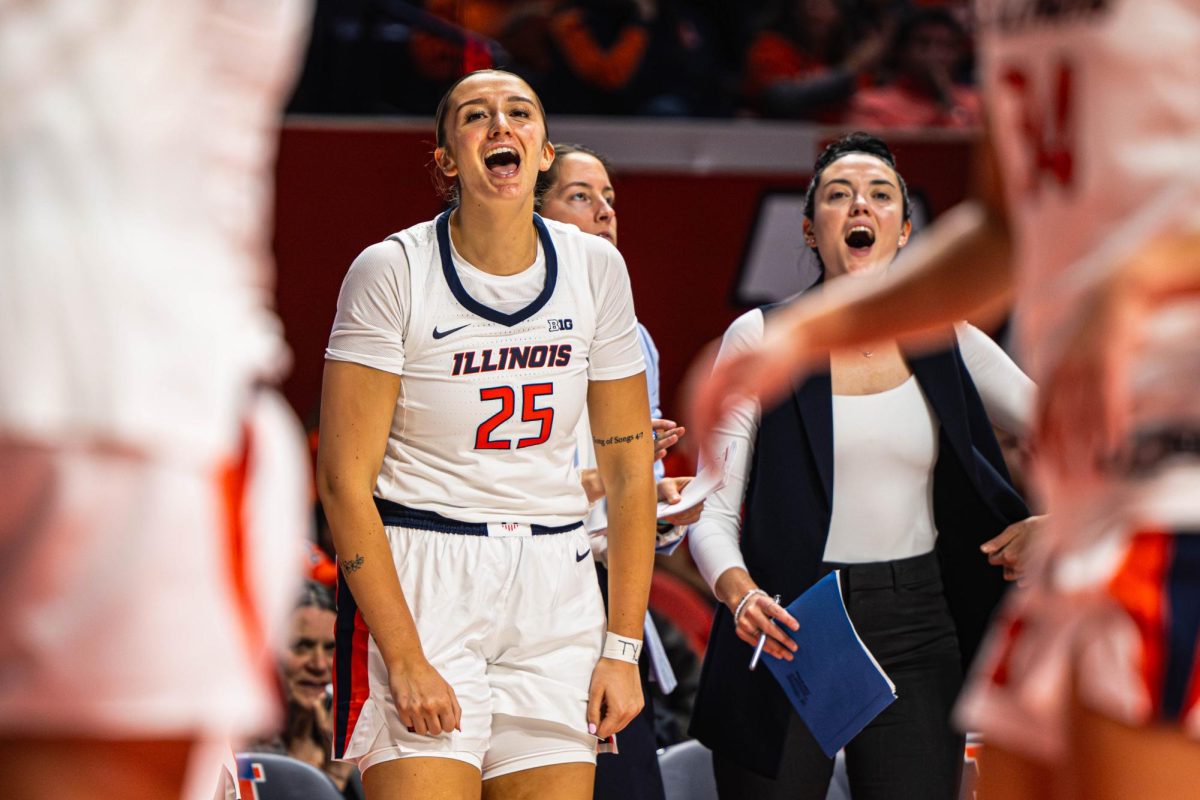 Sophomore center Hayven Smith celebrates on the bench following an Illinois basket during their game against Western Kentucky on Nov. 26. Illinois would go on to win the game 70-41.