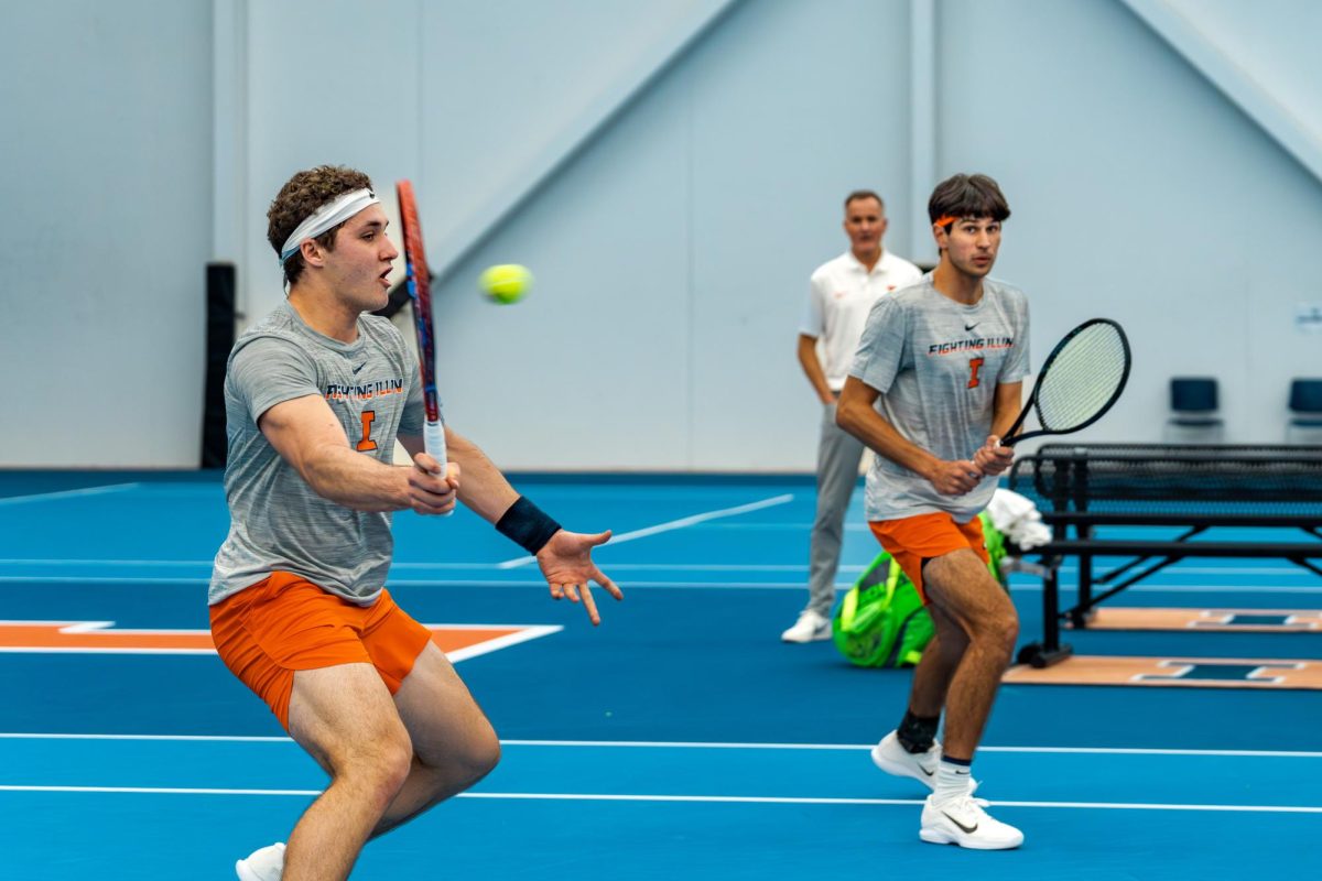 Freshman David Bakonyi (left) returns a volley against Oregon as redshirt sophomore Zach Viiala (right) watches at Atkins Tennis Center on March 6.