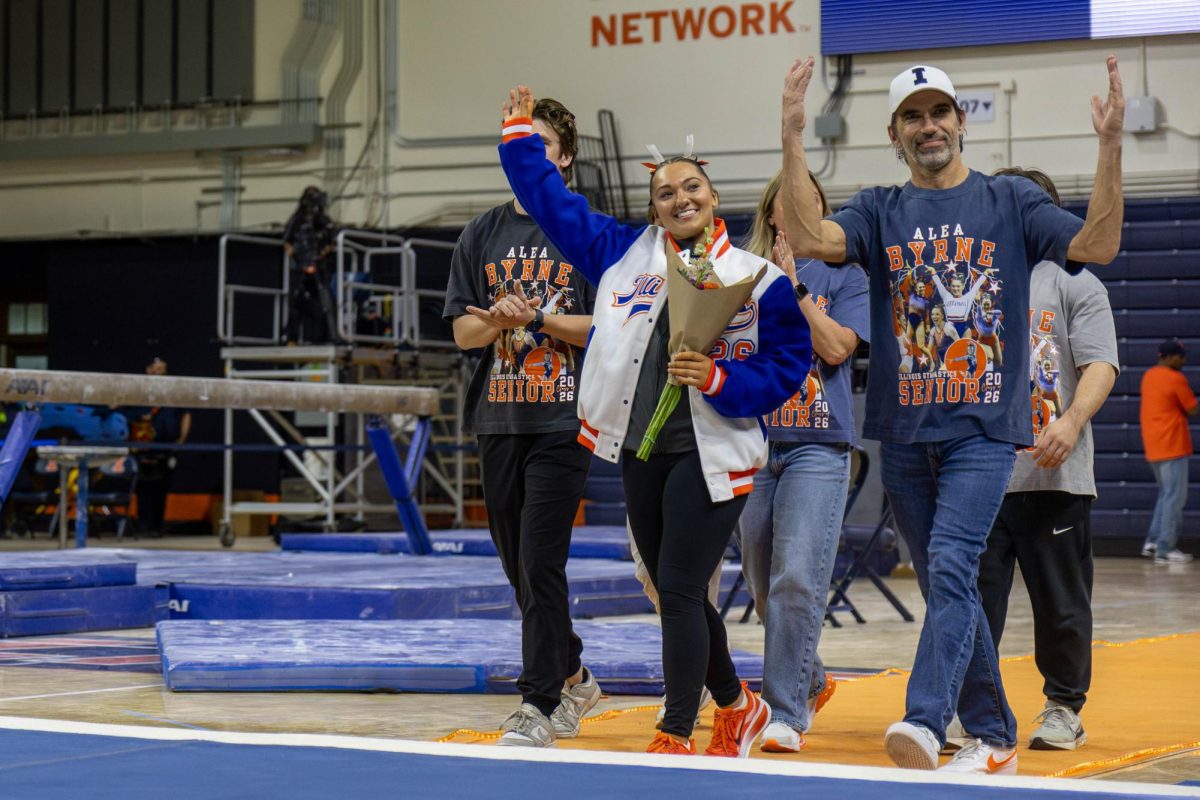 Senior Alea Byrne walks out with her family to be honored after the gymnastics meet against Alabama on March 8 at Huff Hall for Senior Day.