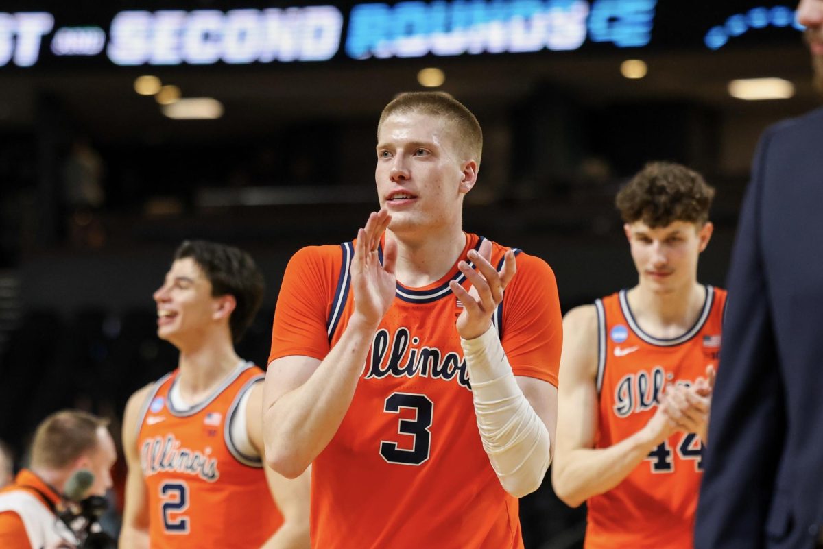 Graduate student forward Ben Humrichous claps as he walks off the court at Bon Secours Wellness Arena following Illinois’ March 21 win in the second round of March Madness.