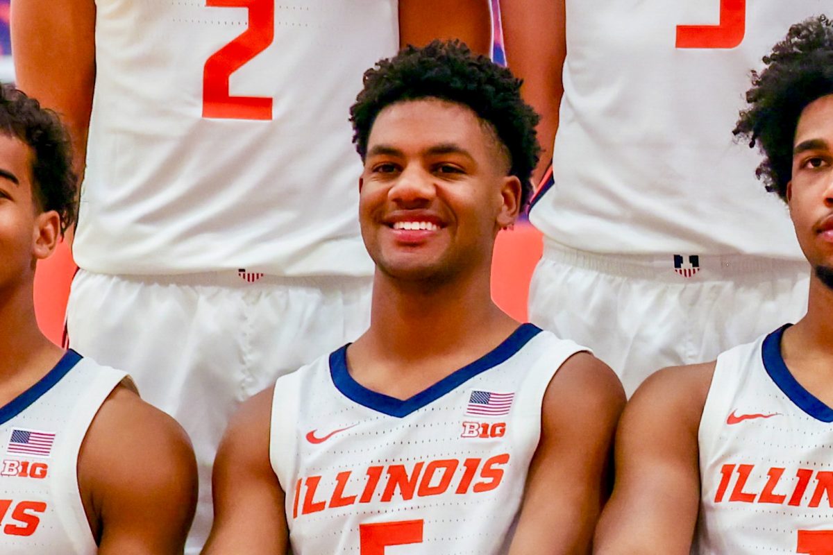Senior guard AJ Redd smiles during a team photo at media day on Oct. 2.
