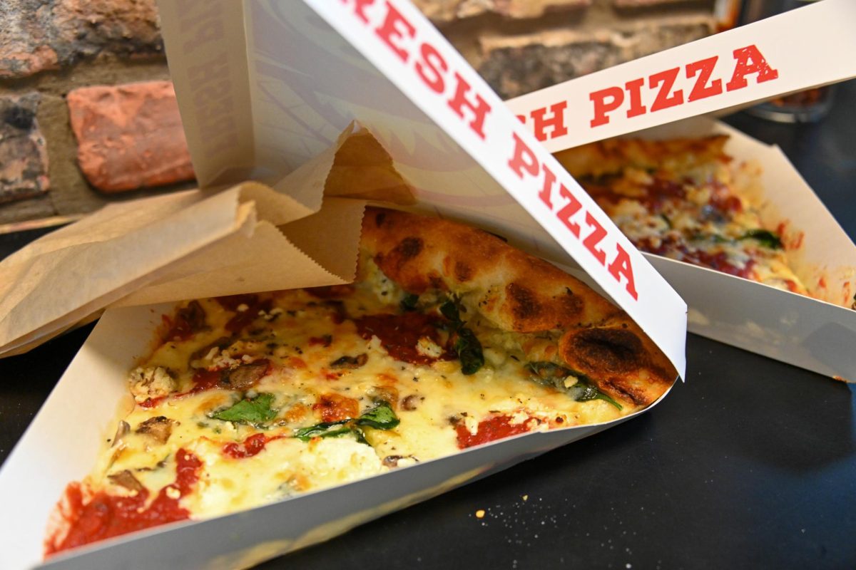 Students order slices of the well-known dish, "The Spotted Goat", in Manolo's Pizza & Empanadas on Feb. 25. The restaurant sits at 1115 W Oregon St in Urbana.