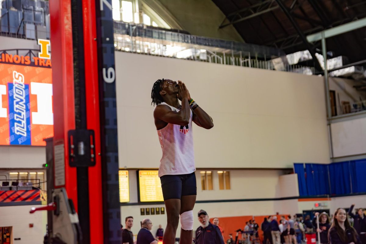 Junior Brenden Vanderpool celebrates after clearing the crossbar in the men’s pole vault event at the Illini Last Chance indoor track and field meet held at the Armory on Friday Feb. 20.