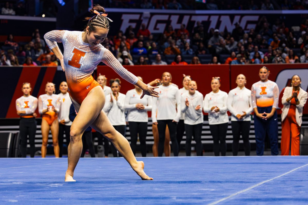 Sophomore Chloe Cho performs her floor routine Feb. 22 in the State Farm Center. The meet versus UCLA drew a crowd of over six thousand people to the stadium, breaking a record for Illinois womens' gymnastics attendance.