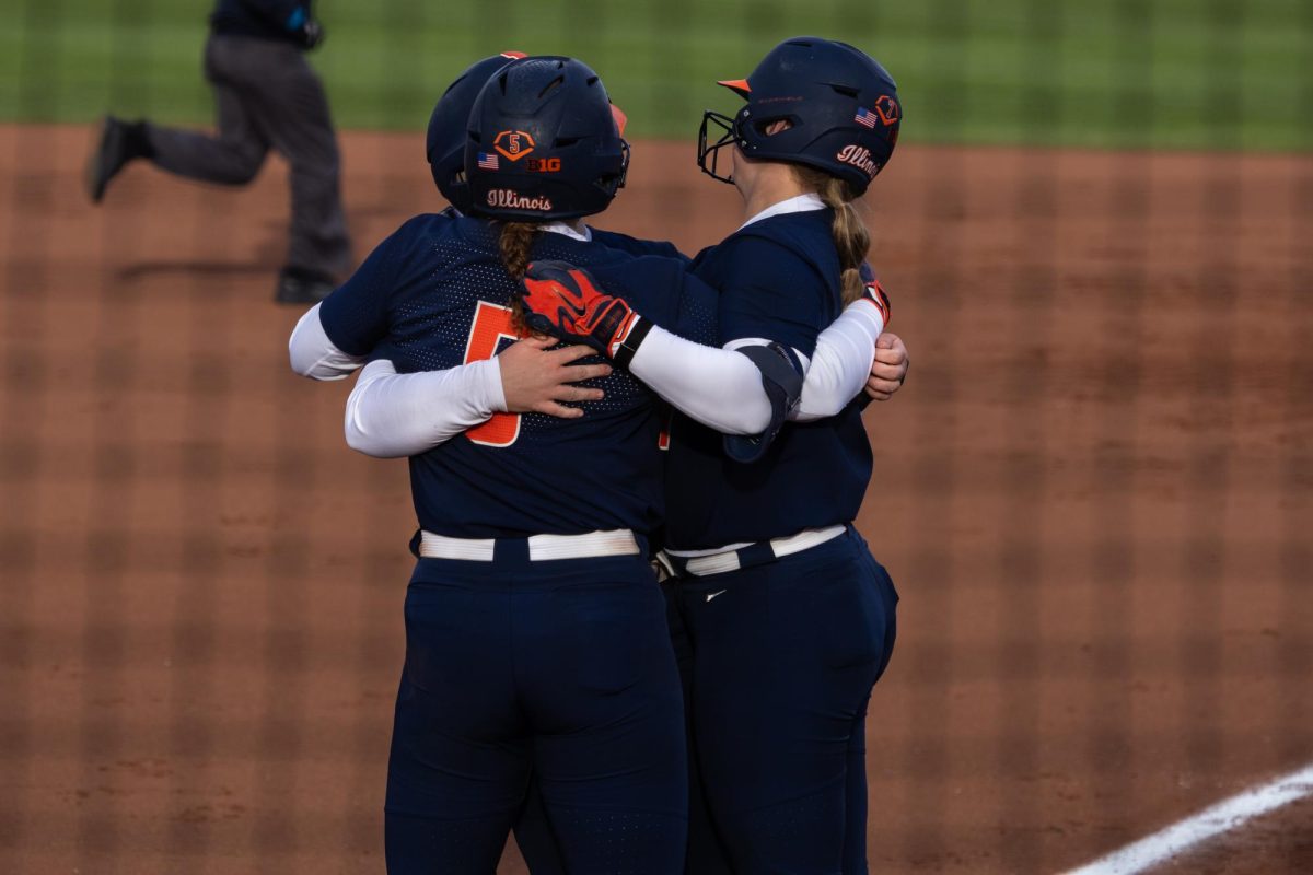 Illinois celebrates after junior infielder Eileen Donahue hit a home run on March 13, at the team's first home game of the season against Iowa. The Illini fell to the Hawkeyes 21-15.
